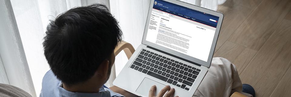 An EB5 investor reviewing the U.S. State Department Visa Bulletin on a laptop at home, tracking Final Action Dates to calculate CSPA protection for dependent children.