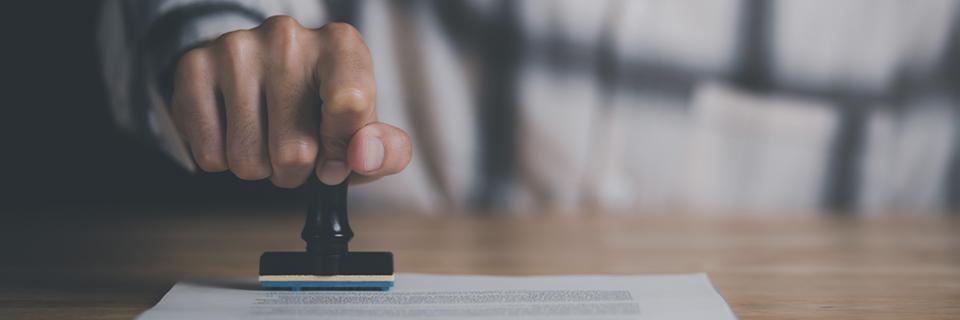 Official approval process symbolizing USCIS review and potential issuance of RFEs to EB5 projects with incomplete documentation.