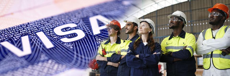 A diverse team of workers in safety gear standing confidently in front of a U.S. visa graphic, representing how EB5 projects link immigration benefits to real job creation.
