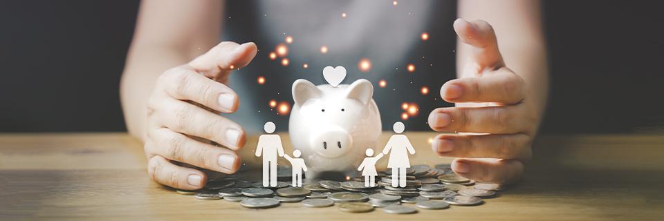 Hands protecting a white piggy bank surrounded by coins and glowing family symbols, representing EB5 investors receiving family financial support for their U.S. immigration journey.