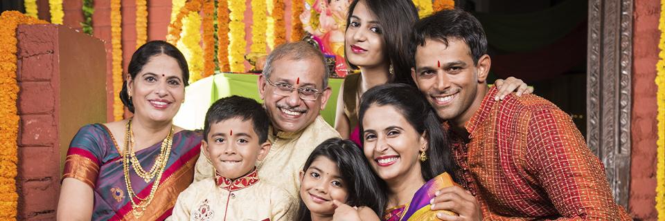 A multigenerational Indian family celebrating together, illustrating how the EB5 program allows investors to immigrate to the United States with their spouse and children and build long-term family stability.