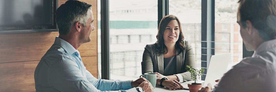 Investor meeting with advisors in a modern office, reflecting professional guidance and due diligence in selecting secure EB5 projects.